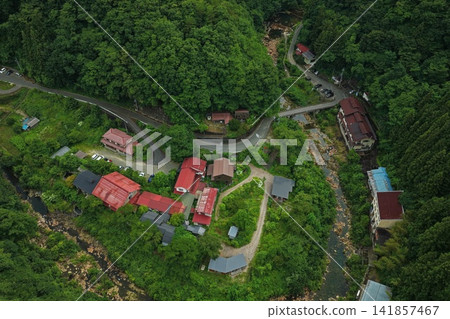 一張空拍照片,展現了群馬縣中之條町的一個山村,以及蜿蜒的道路和河流。 一張空拍照片,展現了群馬縣中之條町的一個山村,以及蜿蜒的道路和河流。 141857467