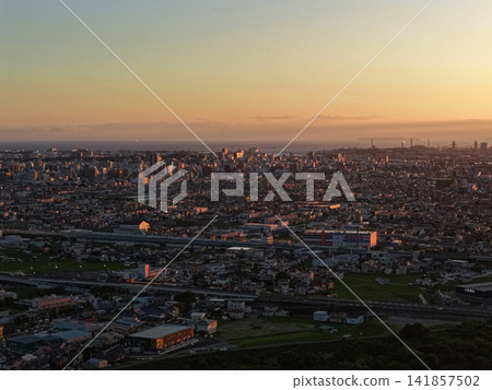 An aerial photograph capturing the evening view of Wakayama city and the Kinokawa River. An aerial photograph capturing the evening view of Wakayama city and the Kinokawa River. 141857502