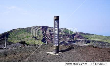 A signpost at the summit of Mt. Mihara on Izu Oshima Island in the Izu Islands of Tokyo, and a magnificent view of the crater. A signpost at the summit of Mt. Mihara on Izu Oshima Island in the Izu Islands of Tokyo, and a magnificent view of the crater. 141858626