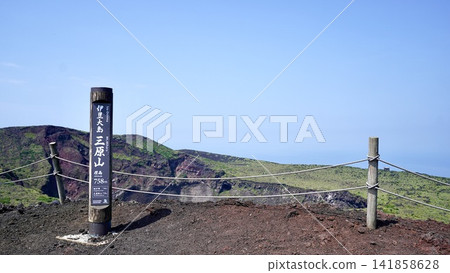 A signpost at the summit of Mt. Mihara on Izu Oshima Island in the Izu Islands of Tokyo, and a magnificent view of the crater. A signpost at the summit of Mt. Mihara on Izu Oshima Island in the Izu Islands of Tokyo, and a magnificent view of the crater. 141858628
