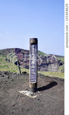 A signpost at the summit of Mt. Mihara on Izu Oshima Island in the Izu Islands of Tokyo, and a magnificent view of the crater. A signpost at the summit of Mt. Mihara on Izu Oshima Island in the Izu Islands of Tokyo, and a magnificent view of the crater. 141858629