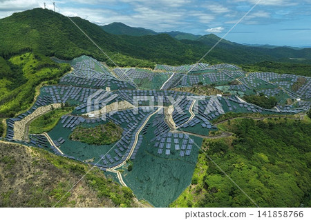 Aerial photograph of a mega solar power plant in the mountainous area of Susami Town, Wakayama Prefecture. Aerial photograph of a mega solar power plant in the mountainous area of Susami Town, Wakayama Prefecture. 141858766