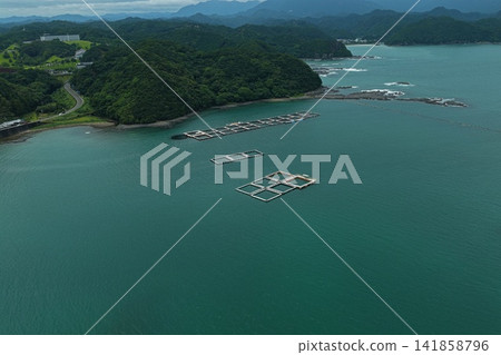 Aerial photograph capturing the coastal area and aquaculture pens of Taiji Town, Wakayama Prefecture. Aerial photograph capturing the coastal area and aquaculture pens of Taiji Town, Wakayama Prefecture. 141858796