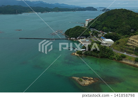 An aerial photograph capturing aquaculture pens and coastal townscape in Taiji, Wakayama Prefecture. An aerial photograph capturing aquaculture pens and coastal townscape in Taiji, Wakayama Prefecture. 141858798