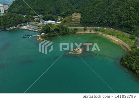 Aerial photograph capturing the bay, aquaculture pens, and coastal settlements of Taiji Town, Wakayama Prefecture. Aerial photograph capturing the bay, aquaculture pens, and coastal settlements of Taiji Town, Wakayama Prefecture. 141858799