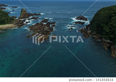 Aerial photograph of the coastline of Kushimoto Town, Wakayama Prefecture, featuring rocky reefs and small islands. 141858818