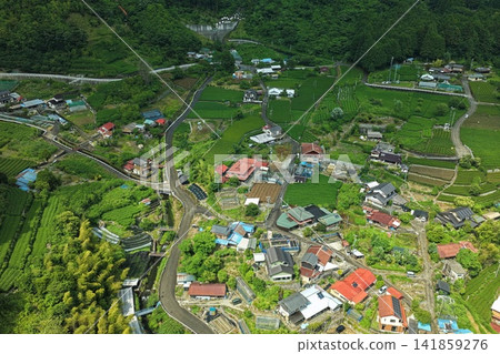 Aerial photograph capturing tea plantations and settlements in the mountainous area of Shizuoka City. Aerial photograph capturing tea plantations and settlements in the mountainous area of Shizuoka City. 141859276
