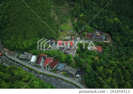Aerial photograph capturing a mountain village and winding road in Umegashima, Shizuoka Prefecture. Aerial photograph capturing a mountain village and winding road in Umegashima, Shizuoka Prefecture. 141859313