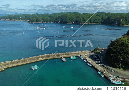 Aerial photograph capturing aquaculture pens and fishing port in Kushimoto Town, Wakayama Prefecture. Aerial photograph capturing aquaculture pens and fishing port in Kushimoto Town, Wakayama Prefecture. 141859326