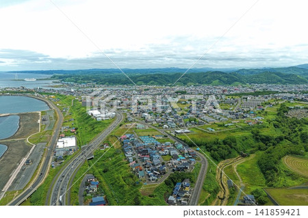 Aerial photograph showing the coastal area, residential area, and wind turbines of Rumoi City, Hokkaido. Aerial photograph showing the coastal area, residential area, and wind turbines of Rumoi City, Hokkaido. 141859421
