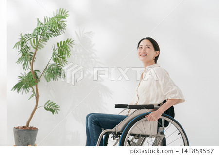 A woman in her 40s in a wheelchair A woman in her 40s in a wheelchair 141859537