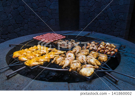 Meat grill over the natural heat of a volcano in Timanfaya National Park on Lanzarote island, Canary, Spain Meat grill over the natural heat of a volcano in Timanfaya National Park on Lanzarote island, Canary, Spain 141860002