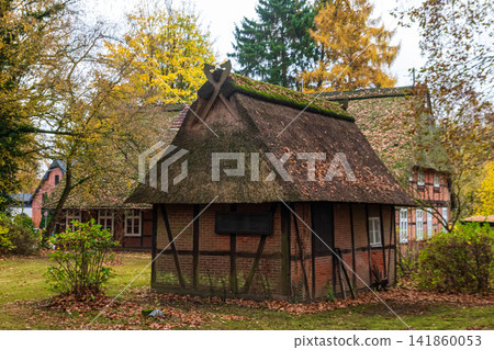 Historic Kleintierstall building - a traditional German half-timbered small barn in Sinstorf, Hamburg, Germany during a beautiful autumn season Historic Kleintierstall building - a traditional German half-timbered small barn in Sinstorf, Hamburg, Germany during a beautiful autumn season 141860053