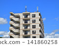 Apartment building under a blue sky 141860258