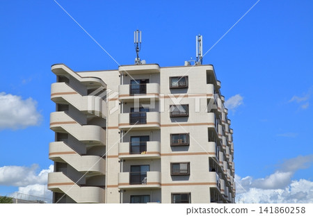 Apartment building under a blue sky Apartment building under a blue sky 141860258