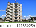 Apartment building in the middle of a grassland 141860259