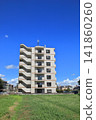 Apartment building in the middle of a grassland 141860260