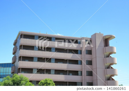 Apartment building under a blue sky Apartment building under a blue sky 141860261