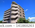 Apartment building under a blue sky 141860263