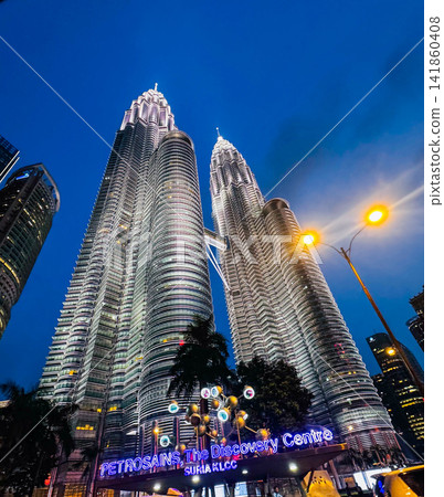 The Petronas Twin Towers, glittering at night, a breathtaking shot taken from directly below. The Petronas Twin Towers, glittering at night, a breathtaking shot taken from directly below. 141860408
