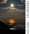 A full moon and moonlight as seen from the summit of Mt. Fuji - a hazy moonlit night, a magnificent view. 141860982