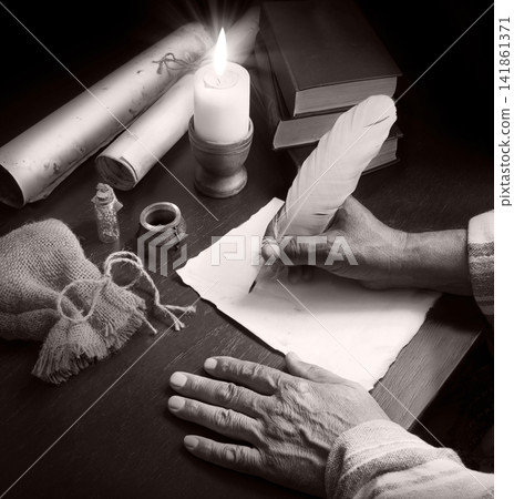 Man writing a letter on a desk Man writing a letter on a desk 141861371