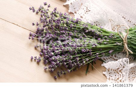 Lavender flowers lie on the table on lace 141861379
