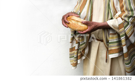Man's hans holding fresh bread Man's hans holding fresh bread 141861382