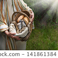 Man holding a basket with fish and bread 141861384