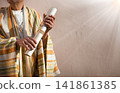 Male hand holding an old scroll 141861385