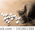 Silver coins in the bag 141861388
