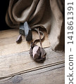 An antique leather sling lies on wooden desk 141861391