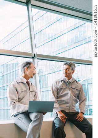 Senior men in work clothes having a meeting Senior men in work clothes having a meeting 141861615