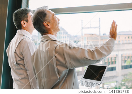 Senior men in work clothes having a meeting Senior men in work clothes having a meeting 141861788