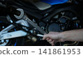 Tool Inspecting Motorcycle Engine. Person Finetuning Bike Engine Before Ride Begins Confidently 141861953