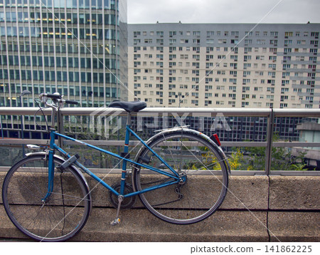 Road bike fastened to railings on background of city panorama 141862225