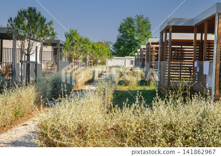 Modern mobile homes with covered porches at resort in Croatia. 141862967