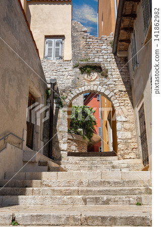 Narrow stone staircase between historic colorful buildings in Rovinj, Croatia. Narrow stone staircase between historic colorful buildings in Rovinj, Croatia. 141862982