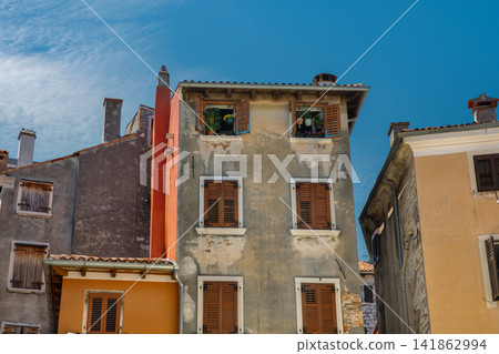 Mediterranean building facades with brown shutters in Rovinj, Croatia. Mediterranean building facades with brown shutters in Rovinj, Croatia. 141862994