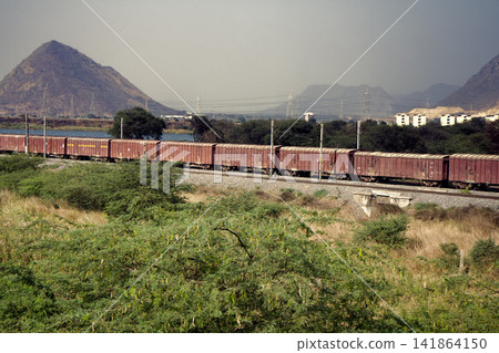 Freight train on background of picturesque Indian countryside Freight train on background of picturesque Indian countryside 141864150