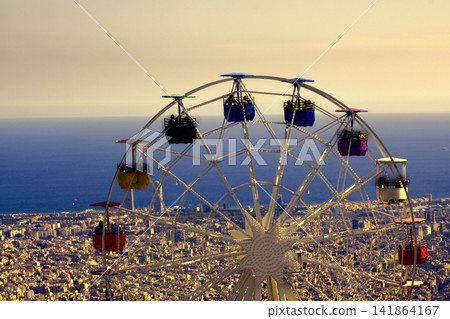 Ferris wheel on background of crowded seaside town Ferris wheel on background of crowded seaside town 141864167