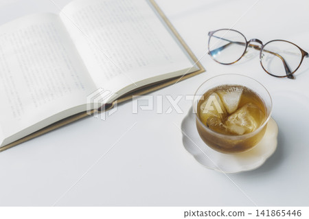 Cold barley tea, a book, and glasses: summer reading time. Cold barley tea, a book, and glasses: summer reading time. 141865446