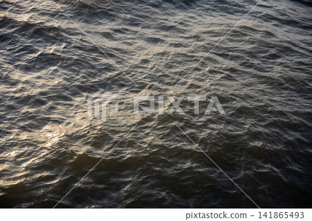 The shimmering and rippling of the water's surface The shimmering and rippling of the water's surface 141865493