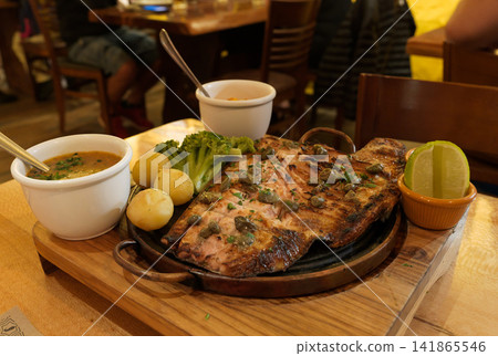 Grilled Brazilian river fish served with potatoes and broccoli. Grilled Brazilian river fish served with potatoes and broccoli. 141865546