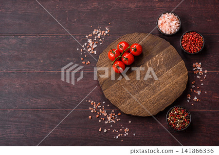 A square wooden cutting board for home food preparation. A wooden cutting board A square wooden cutting board for home food preparation. A wooden cutting board 141866336