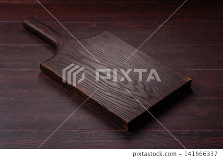 A square wooden cutting board for home food preparation. A wooden cutting board A square wooden cutting board for home food preparation. A wooden cutting board 141866337