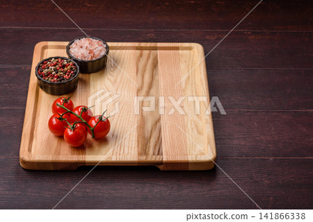 A square wooden cutting board for home food preparation. A wooden cutting board A square wooden cutting board for home food preparation. A wooden cutting board 141866338