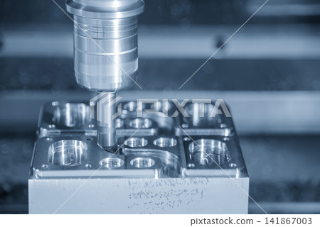 Metal part edge chamfering process on CNC milling machine in blue tone lighting 141867003