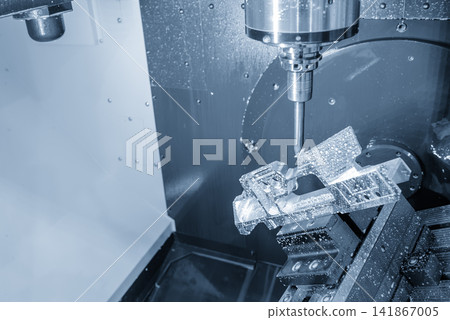 5 axis CNC milling machine cutting aerospace part using end mill tool in blue tone lighting. 5 axis CNC milling machine cutting aerospace part using end mill tool in blue tone lighting. 141867005