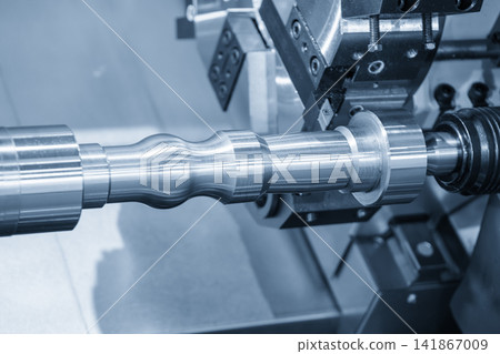 CNC lathe machine forming cut process on metal shaft part in blue tone lighting CNC lathe machine forming cut process on metal shaft part in blue tone lighting 141867009